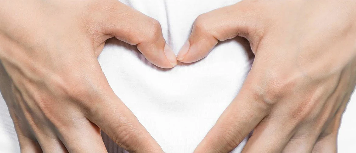 woman holding heart over her stomach for gastrointestinal health