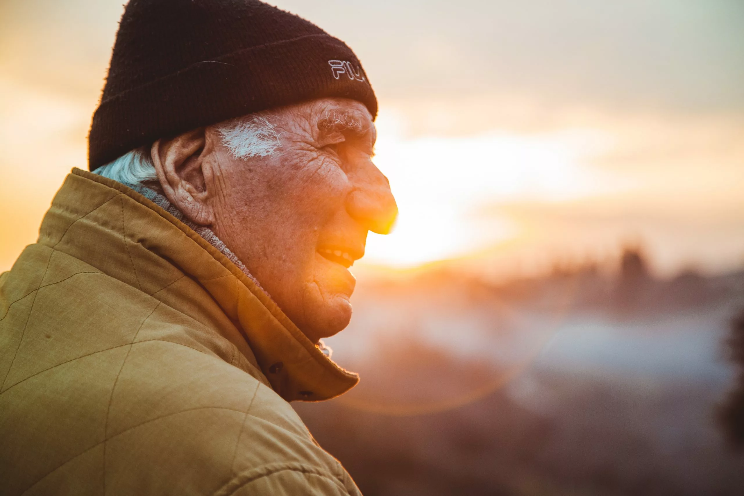 Older man outside at sunset