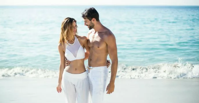Couple on beach in bathing suits