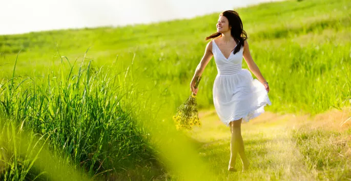 woman walking through a field